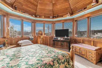 a bedroom with a large bed in a room with windows at Clarks Summit Gem w/ Private Yard & Parking in Clarks Summit