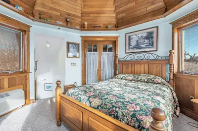 a bedroom with a bed and wooden ceilings and windows at Clarks Summit Gem w/ Private Yard & Parking in Clarks Summit
