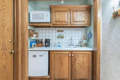 a small kitchen with a sink and a microwave at Clarks Summit Gem w/ Private Yard & Parking in Clarks Summit