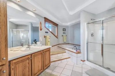 a bathroom with a tub and a sink and a shower at Clarks Summit Gem w/ Private Yard & Parking in Clarks Summit