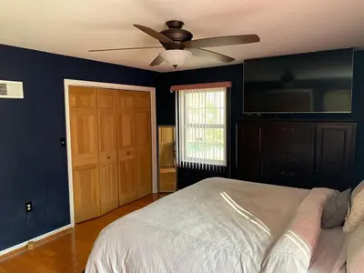 a bedroom with a bed and a ceiling fan at VIP Pocono Escape Water Park,Casino,All Inclusive in East Stroudsburg