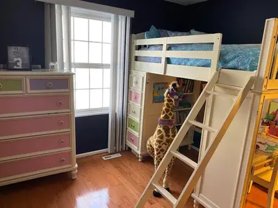 a giraffe is standing next to a bunk bed at VIP Pocono Escape Water Park,Casino,All Inclusive in East Stroudsburg