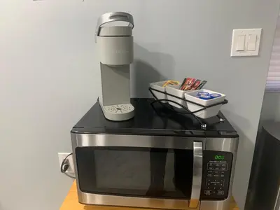 a coffee maker sitting on top of a microwave at A Cozy Corner with kitchen and parking in Drexel Hill