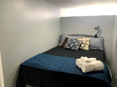 a bedroom with a bed with two towels on it at A Cozy Corner with kitchen and parking in Drexel Hill