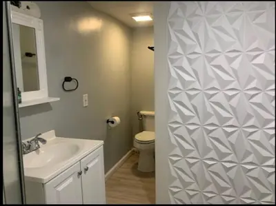 a bathroom with a white toilet and a sink at A Cozy Corner with kitchen and parking in Drexel Hill
