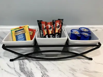 a glass table with snacks on top of a counter at A Cozy Corner with kitchen and parking in Drexel Hill