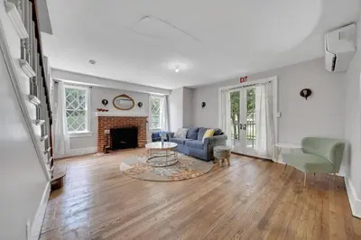 a living room with a couch and a fireplace at Cozy Cottage House - Pool & Hot Tub in Liberty