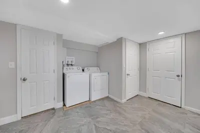 a white laundry room with a washer and dryer at Cozy Cottage House - Pool & Hot Tub in Liberty
