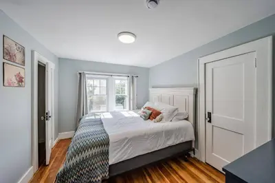 a bedroom with a bed with a teddy bear on it at Cozy Cottage House - Pool & Hot Tub in Liberty