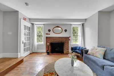 a living room with a couch and a fireplace at Cozy Cottage House - Pool & Hot Tub in Liberty
