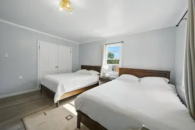 a bedroom with two beds and a window at Liberty Lakefront Home - Pool, Hot Tub, Sauna in Liberty