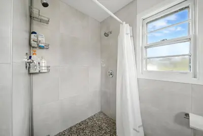 a bathroom with a shower with a shower curtain at Liberty Lakefront Home - Pool, Hot Tub, Sauna in Liberty