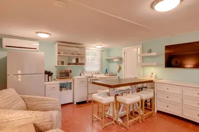 a kitchen with a table and chairs and a refrigerator at Fish and Hike Lakeside Poconos Retreat, Unit 3 in Bangor