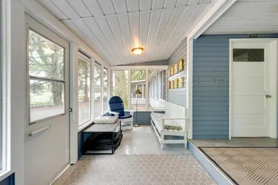 a front porch of a home with a blue house at Fish and Hike Lakeside Poconos Retreat, Unit 3 in Bangor