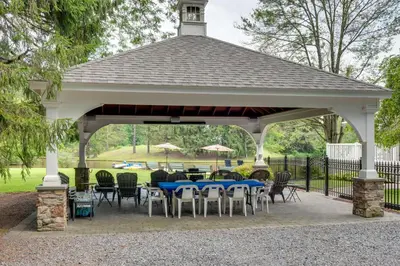 a pavilion with tables and chairs in a park at Fish and Hike Lakeside Poconos Retreat, Unit 3 in Bangor