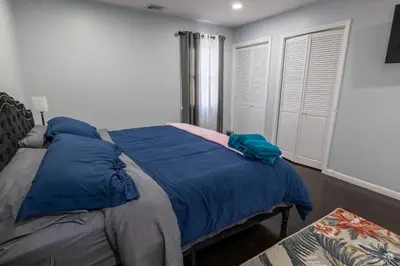 a bedroom with a bed with blue pillows on it at New 3 Bed & 1 Bed Apt Lake Park Station EWR Airport Path Train Subway Bus Hospital Rahway NJ Manhattan NYC in Rahway