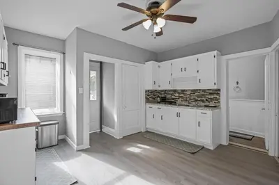 a kitchen with white cabinets and a ceiling fan at Cozy Home, 19 min to NYC, 3 Car Driveway in Wallington