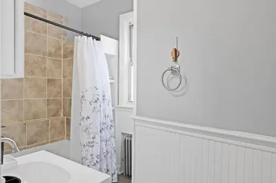 a bathroom with a shower curtain and a sink at Cozy Home, 19 min to NYC, 3 Car Driveway in Wallington