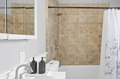 a bathroom with a shower and a toilet and a sink at Cozy Home, 19 min to NYC, 3 Car Driveway in Wallington