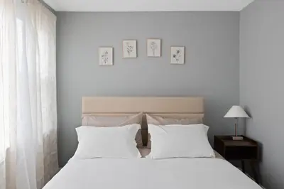 a bedroom with two beds with white pillows at Cozy Home, 19 min to NYC, 3 Car Driveway in Wallington