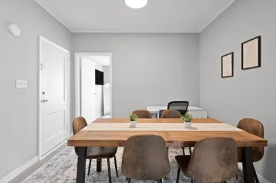 a dining room with a wooden table and chairs at Cozy Home, 19 min to NYC, 3 Car Driveway in Wallington
