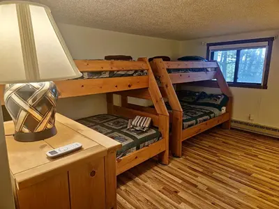 a bedroom with two bunk beds and a desk with a lamp at Rustic Mountain Escape Waterpark, Ski & Views! in Tannersville
