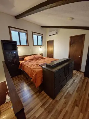 a bedroom with a large bed with a dresser and a desk at Rustic Mountain Escape Waterpark, Ski & Views! in Tannersville