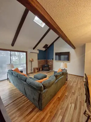 a living room with a large couch in a room at Rustic Mountain Escape Waterpark, Ski & Views! in Tannersville
