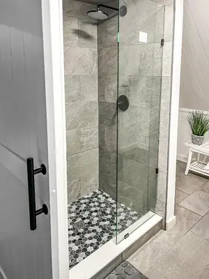 a shower with a glass door in a bathroom at Italy Inspired Lakeview Chalet with Hot Tub in Lake Harmony