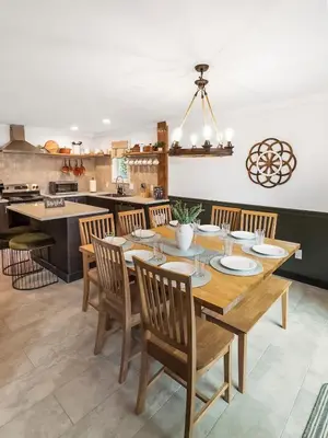 a dining room with a wooden table and chairs at Italy Inspired Lakeview Chalet with Hot Tub in Lake Harmony