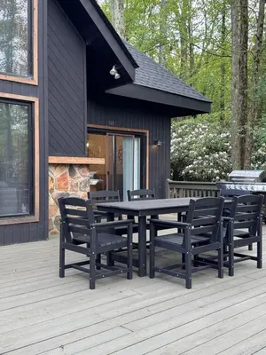a patio with a table and chairs on a deck at Italy Inspired Lakeview Chalet with Hot Tub in Lake Harmony