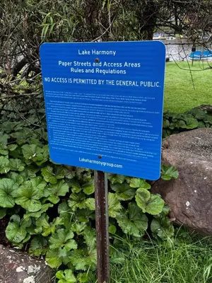a blue sign in front of some plants at Italy Inspired Lakeview Chalet with Hot Tub in Lake Harmony