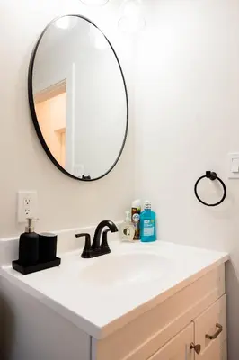 a bathroom with a sink and a mirror at Joynest Place in Newark