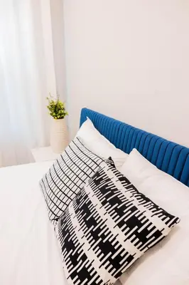 a bed with a black and white blanket on it at Joynest Place in Newark