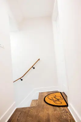 a rug on the floor in a room with a white wall at Joynest Place in Newark