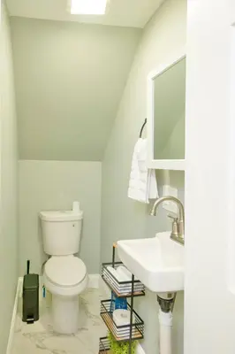 a bathroom with a toilet and a sink at The Hillside | Full House | Parking | Near EWR-NYC in Newark