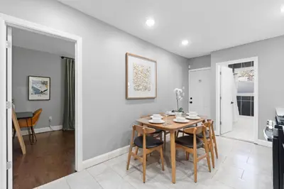 a kitchen and dining room with a table and chairs at Urban Charm | Near EWR Airport Easy Access to NYC in Newark