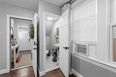 a bathroom with a toilet and a window at Urban Charm | Near EWR Airport Easy Access to NYC in Newark