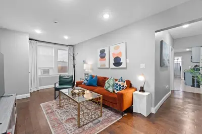 a living room with a couch and a table at Urban Charm | Near EWR Airport Easy Access to NYC in Newark