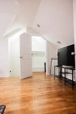 an empty living room with a flat screen tv at Joynest Loft - Private Entry & Bath in Newark