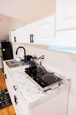 a kitchen counter with a laptop on top of it at Joynest Loft - Private Entry & Bath in Newark