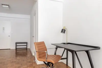 a desk and a chair in a room at Blueground Midtown East doorman nr MoMA NYC-1786 in New York