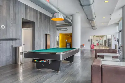 a pool table in the middle of a room at Blueground Hells Kitchen view nr Hudson River NYC-1905 in New York