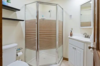 a bathroom with a shower and a toilet and a sink at 5 min to Lake Chic Cozy Hot Tub in Sparta