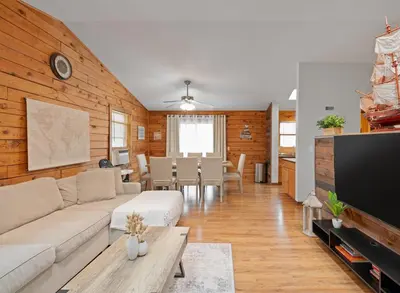 a living room with a couch and a tv at 5 min to Lake Chic Cozy Hot Tub in Sparta