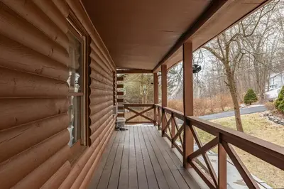 a porch of a wooden house with a window at 5 min to Lake Chic Cozy Hot Tub in Sparta