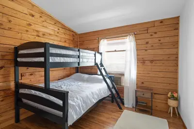 a bedroom with a bunk bed and a window at 5 min to Lake Chic Cozy Hot Tub in Sparta
