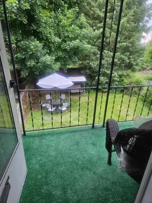 a screened in porch with an umbrella and a table at Super Comfy Entire Home in Scranton