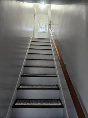 a staircase leading up to a door with a window at Super Comfy Entire Home in Scranton