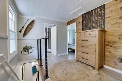 a staircase in a home with a wooden wall at Heatherbell, A Lakeside Retreat in Saylorsburg